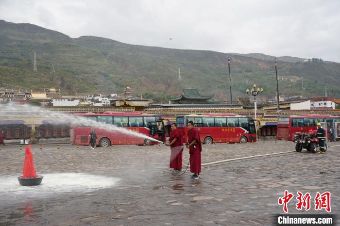 图为僧侣志愿消防队开展灭火技能训练。　潘雨洁 摄